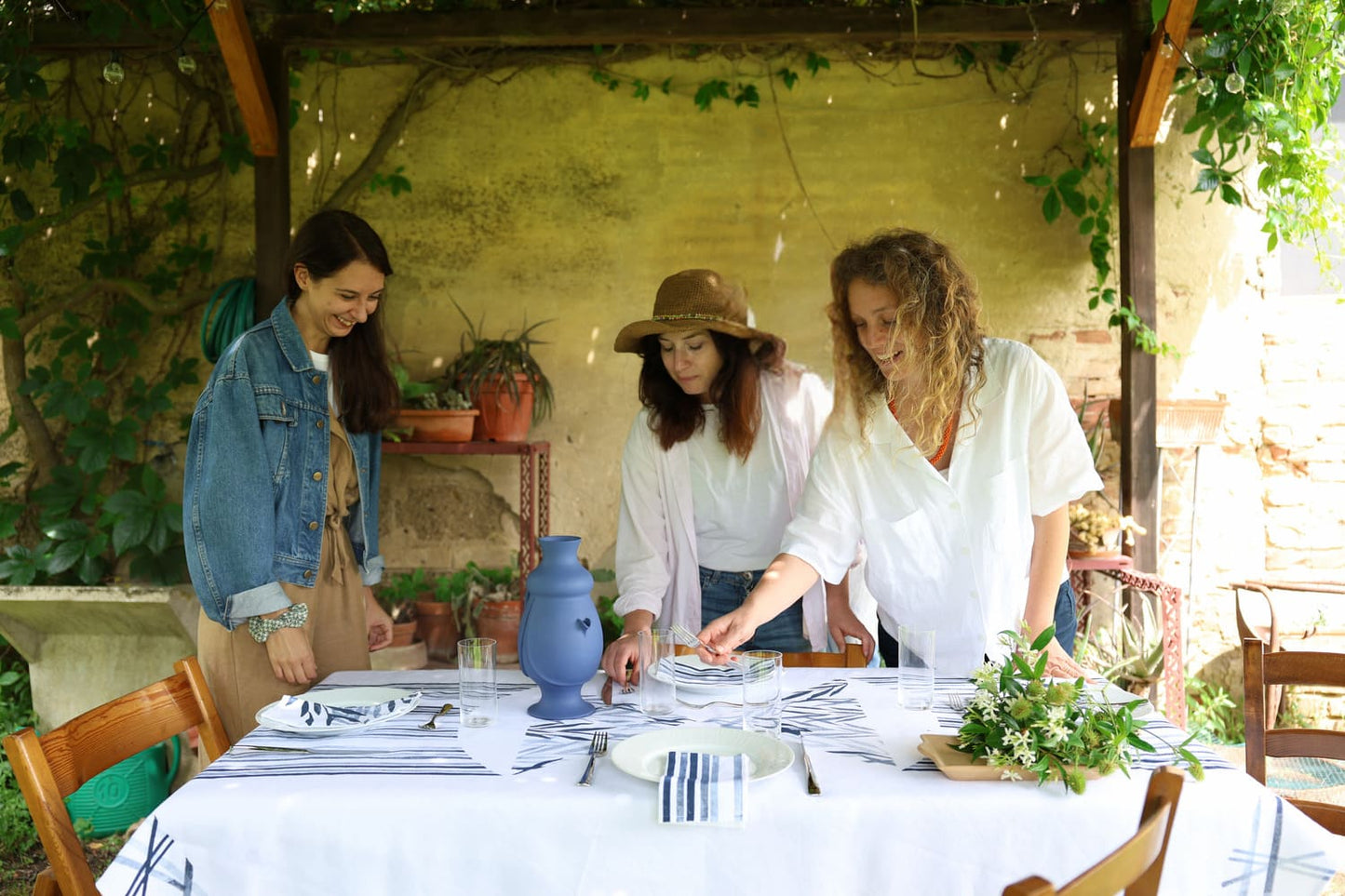 Tuscany countryside dining scene featuring a traditional sicilian ceramic jug.