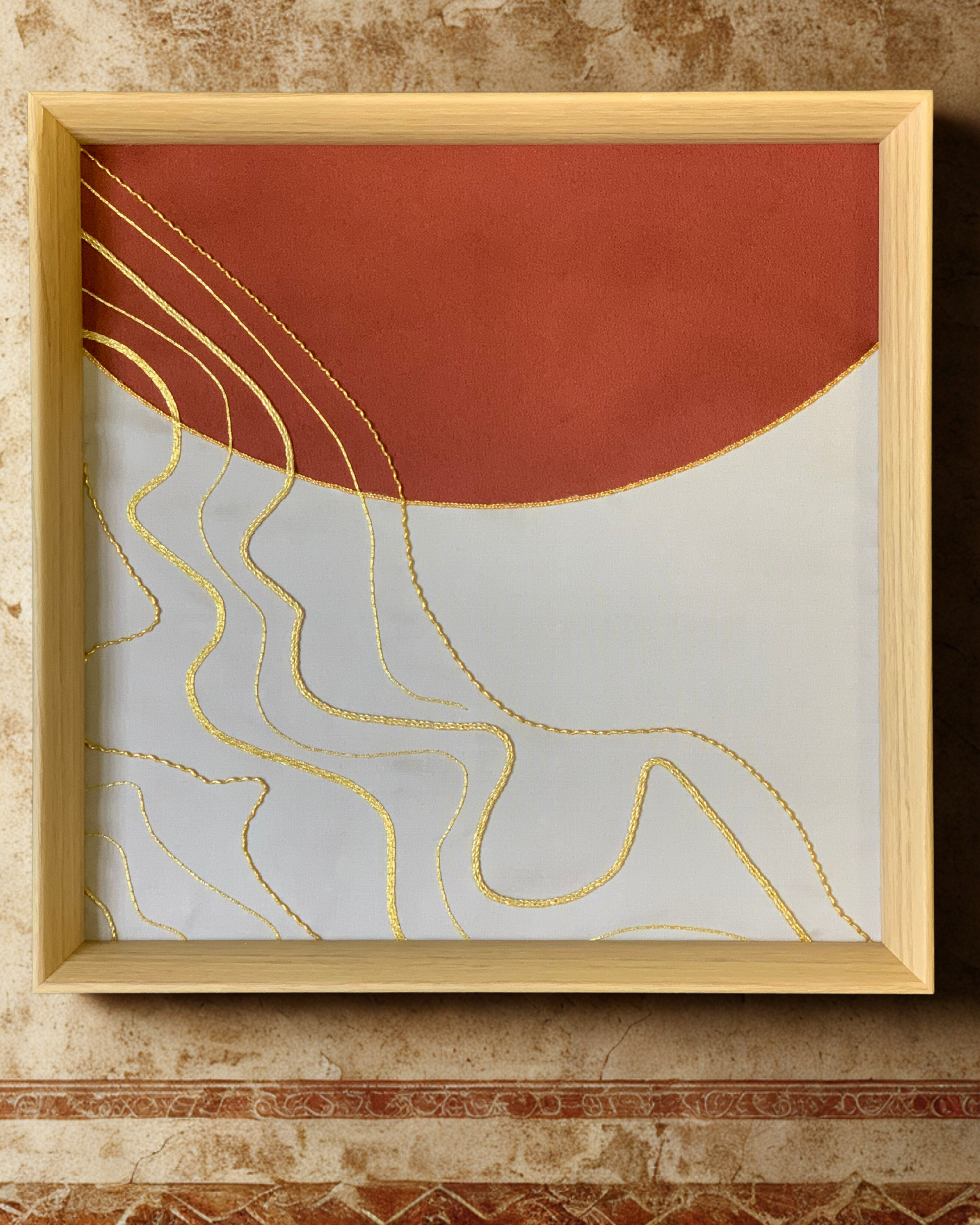 Gold embroidery artwork hand-stitched with 24kt gold threads on fine fabric.