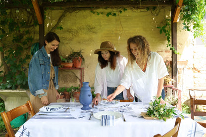 Tuscany countryside dining scene featuring a traditional sicilian ceramic jug.
